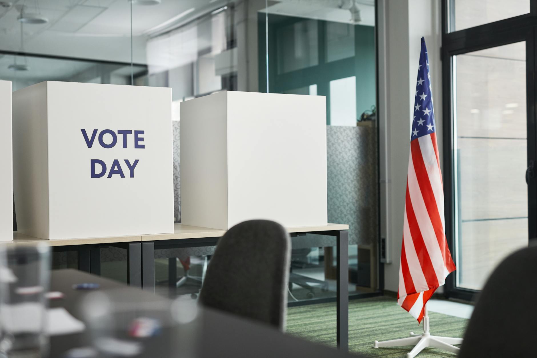 Person casting ballot in voting booth during election