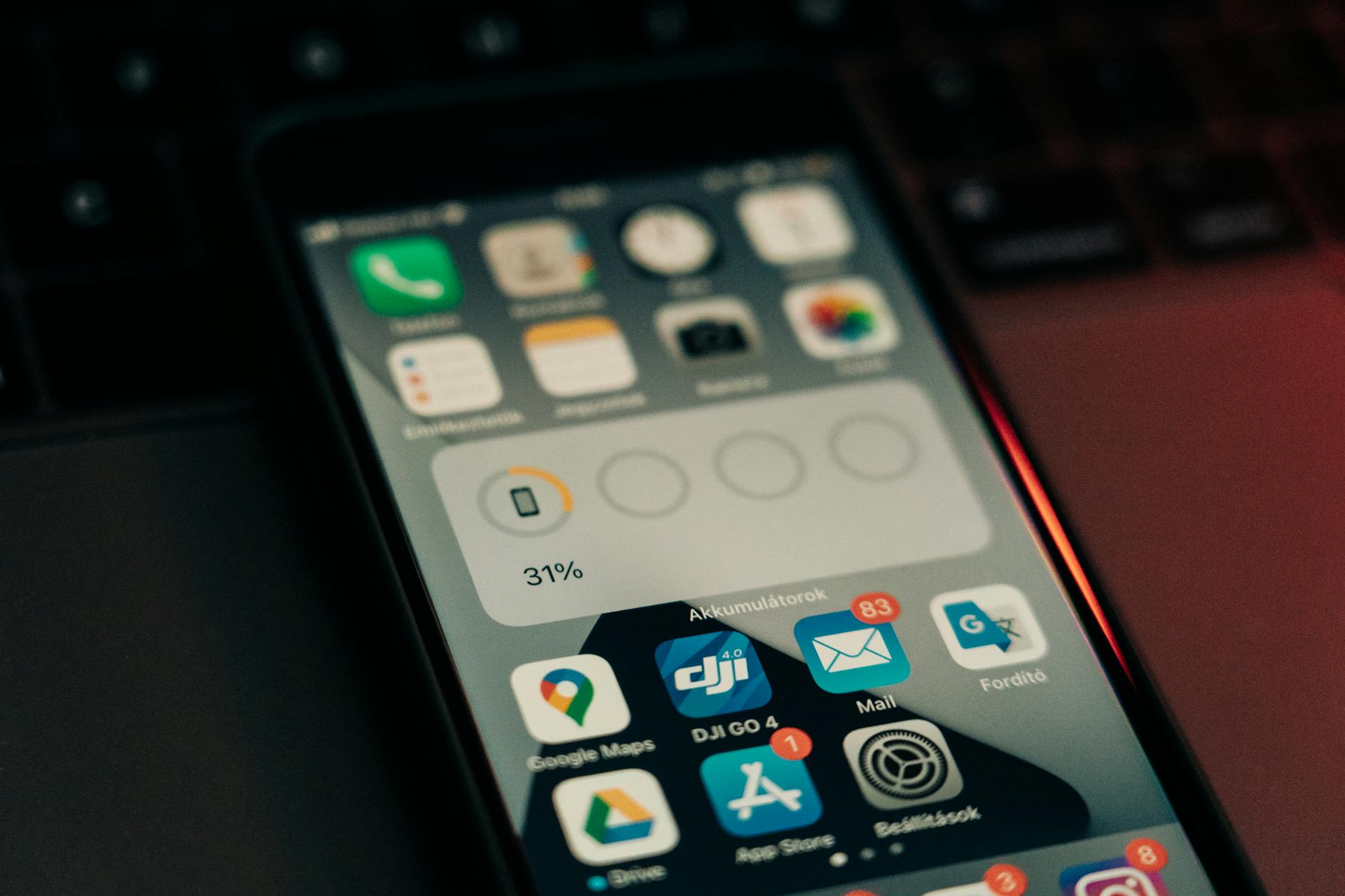Person checking weather forecast on mobile phone displaying temperature and precipitation data