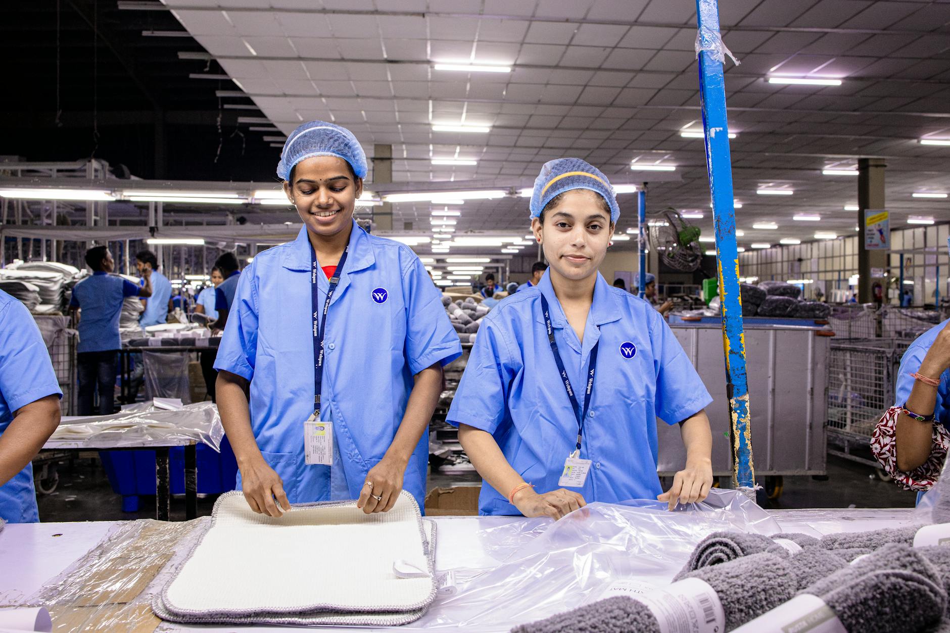 Industrial workers operating manufacturing equipment in a modern processing facility