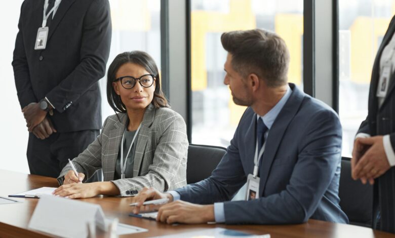 Professional business meeting with diverse group of people discussing around conference table