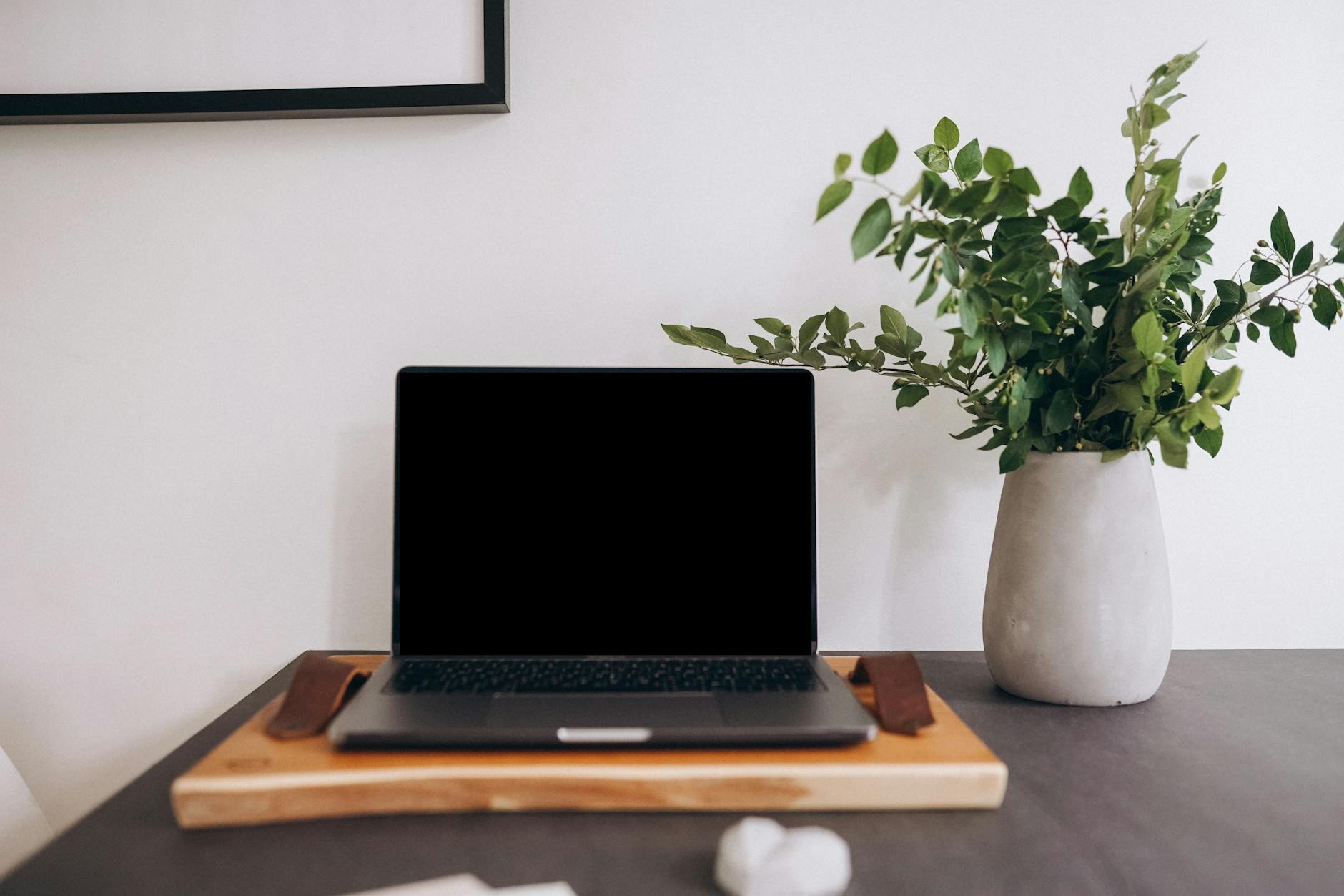 Person working on laptop in home office setting representing remote work