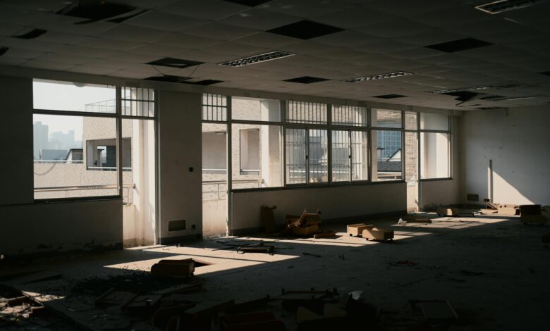 Modern office building exterior with empty windows reflecting the commercial real estate vacancy crisis