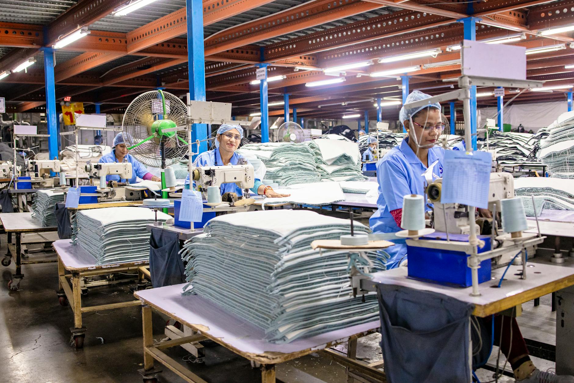 Manufacturing workers collaborating on production line in modern industrial facility