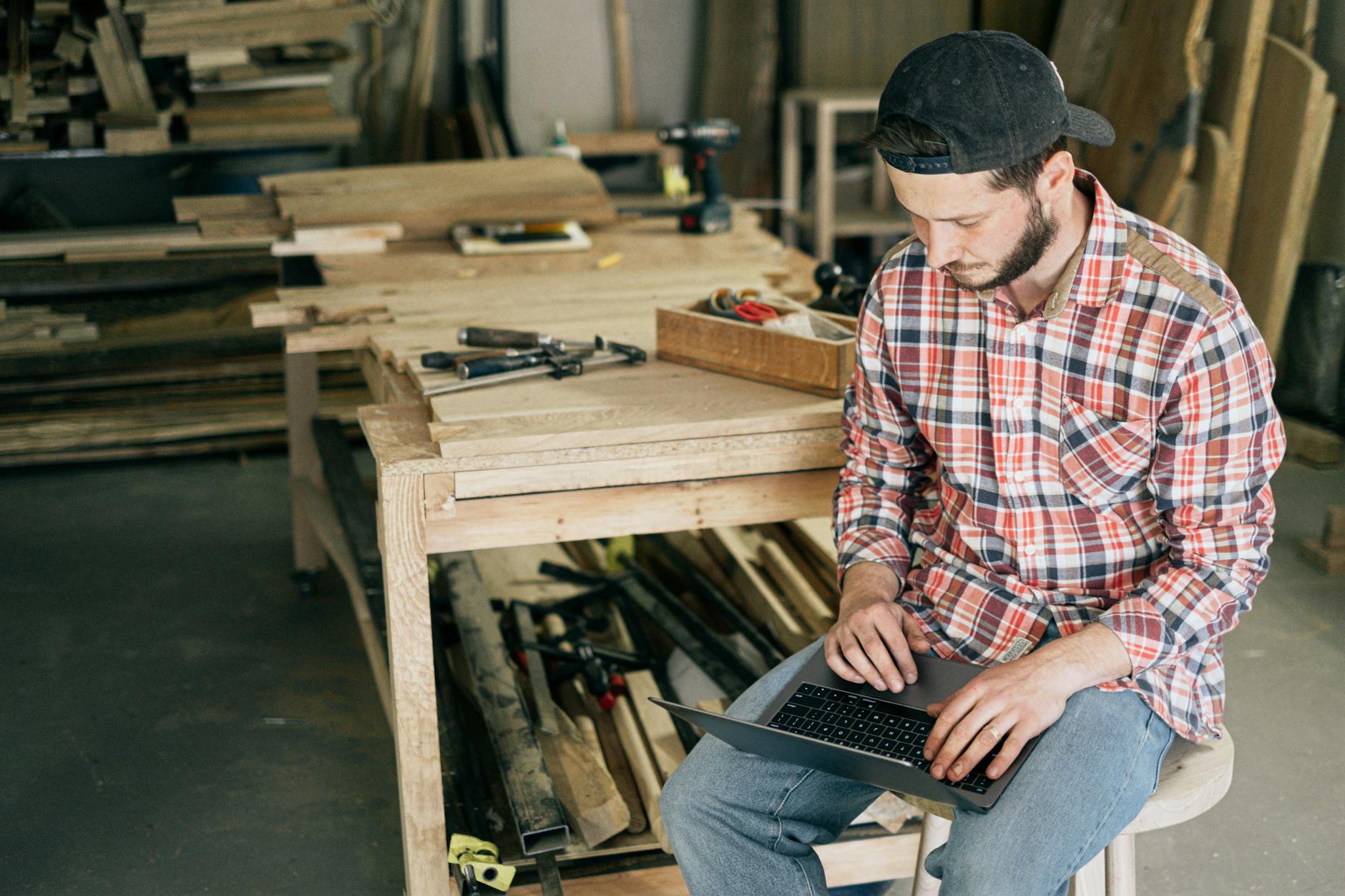 Small business owner working on laptop with AI tools and software applications
