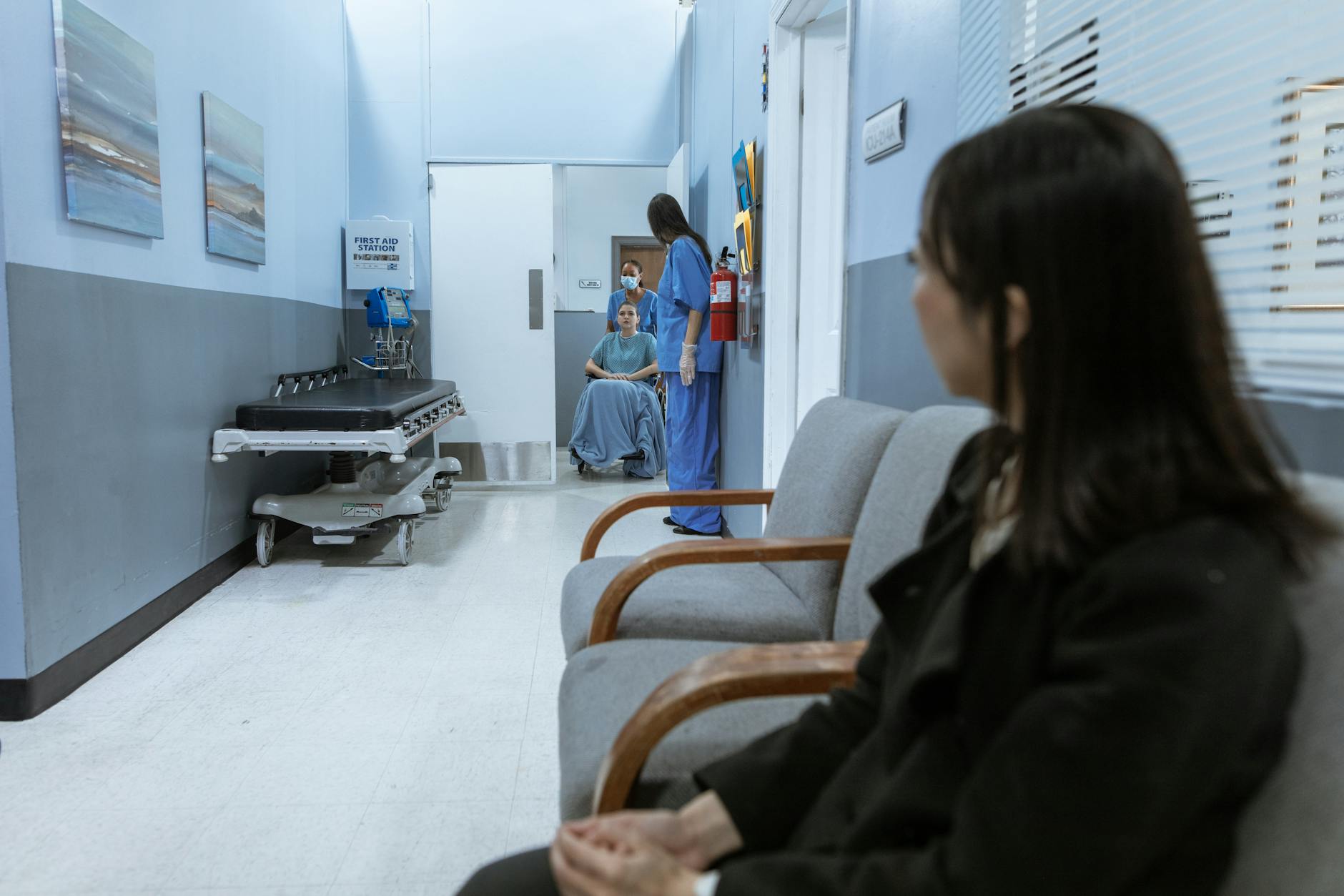 Modern hospital corridor with medical equipment and clean white walls