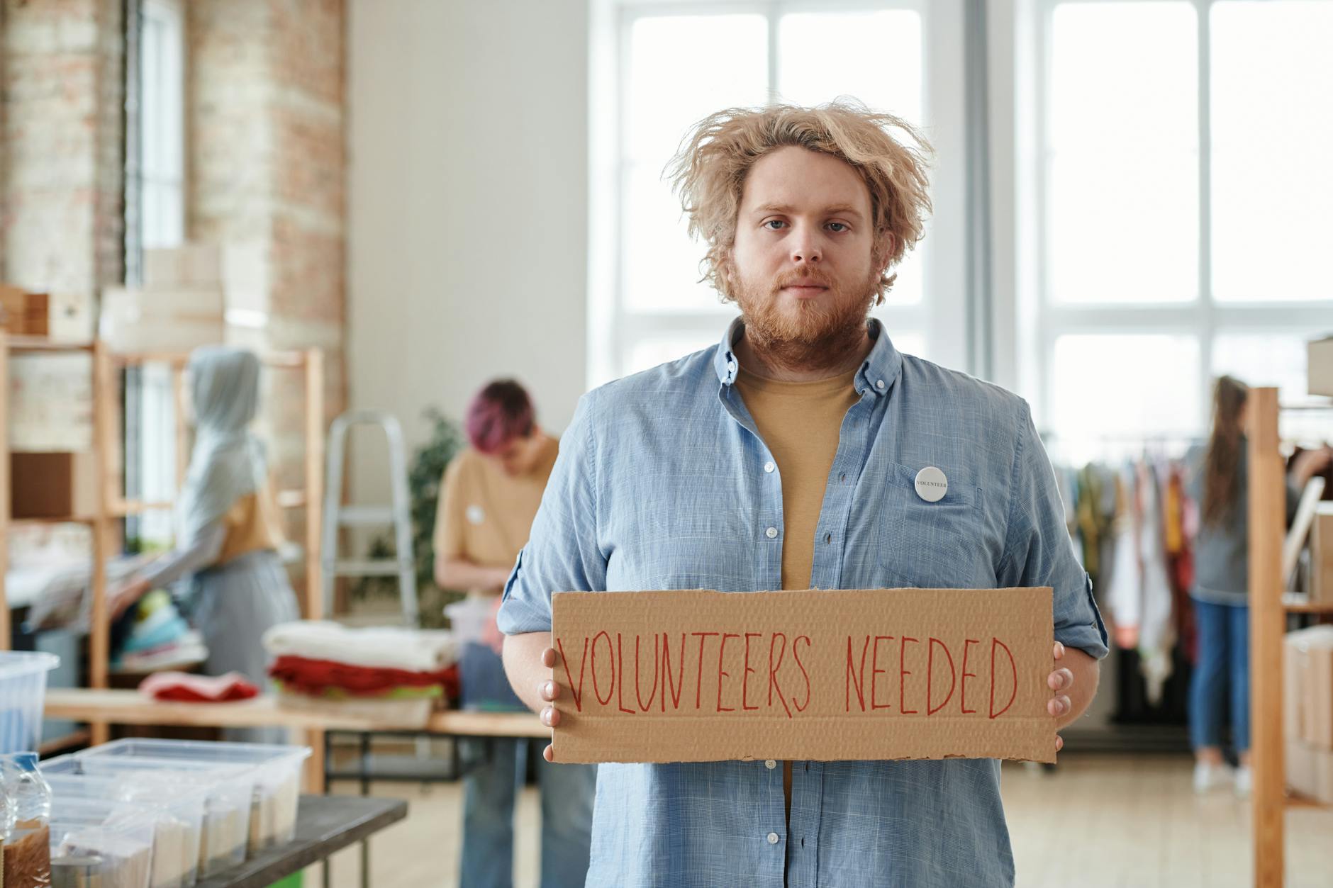 Group of diverse employees volunteering at community outreach event in office setting