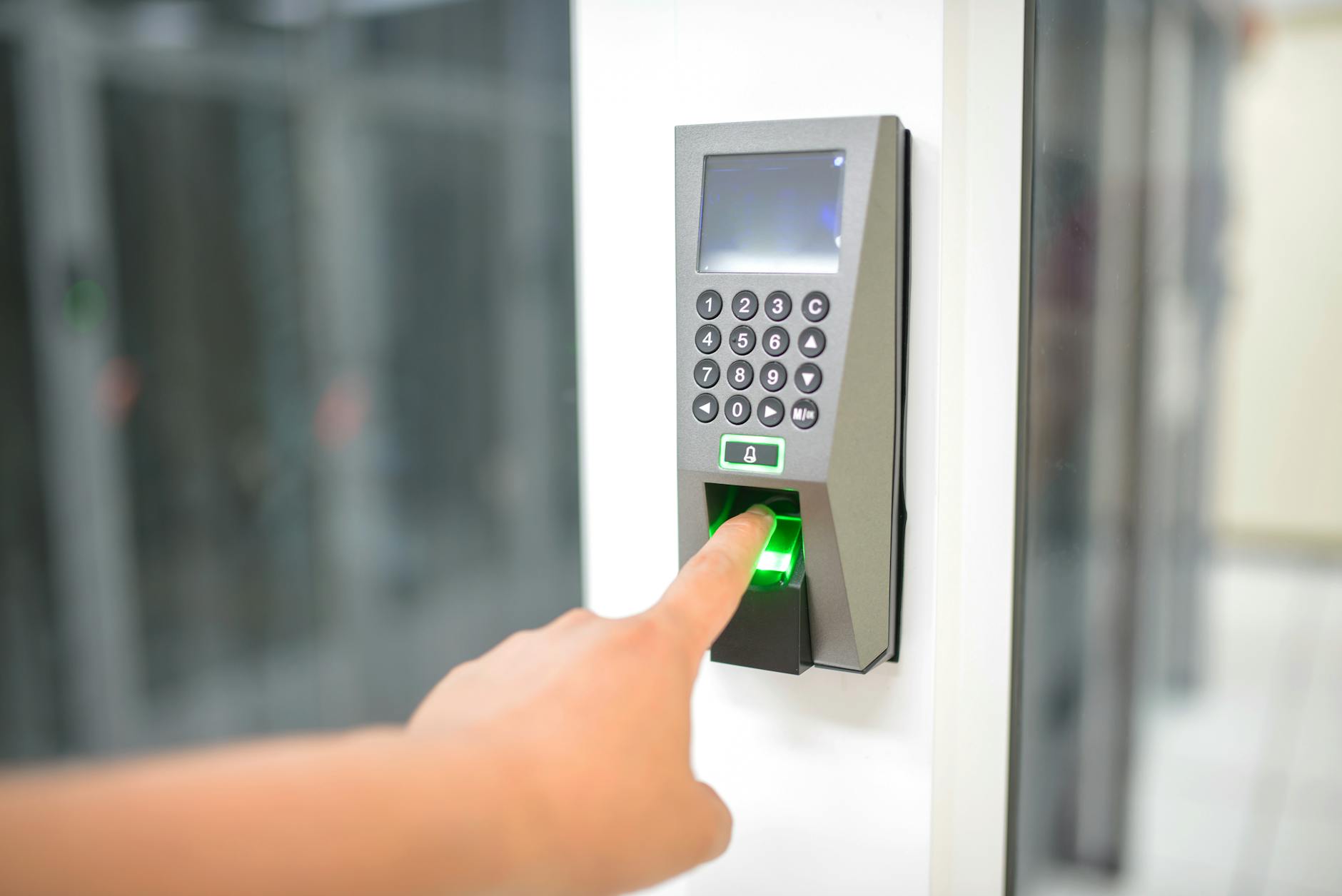 Person using fingerprint scanner at checkout terminal