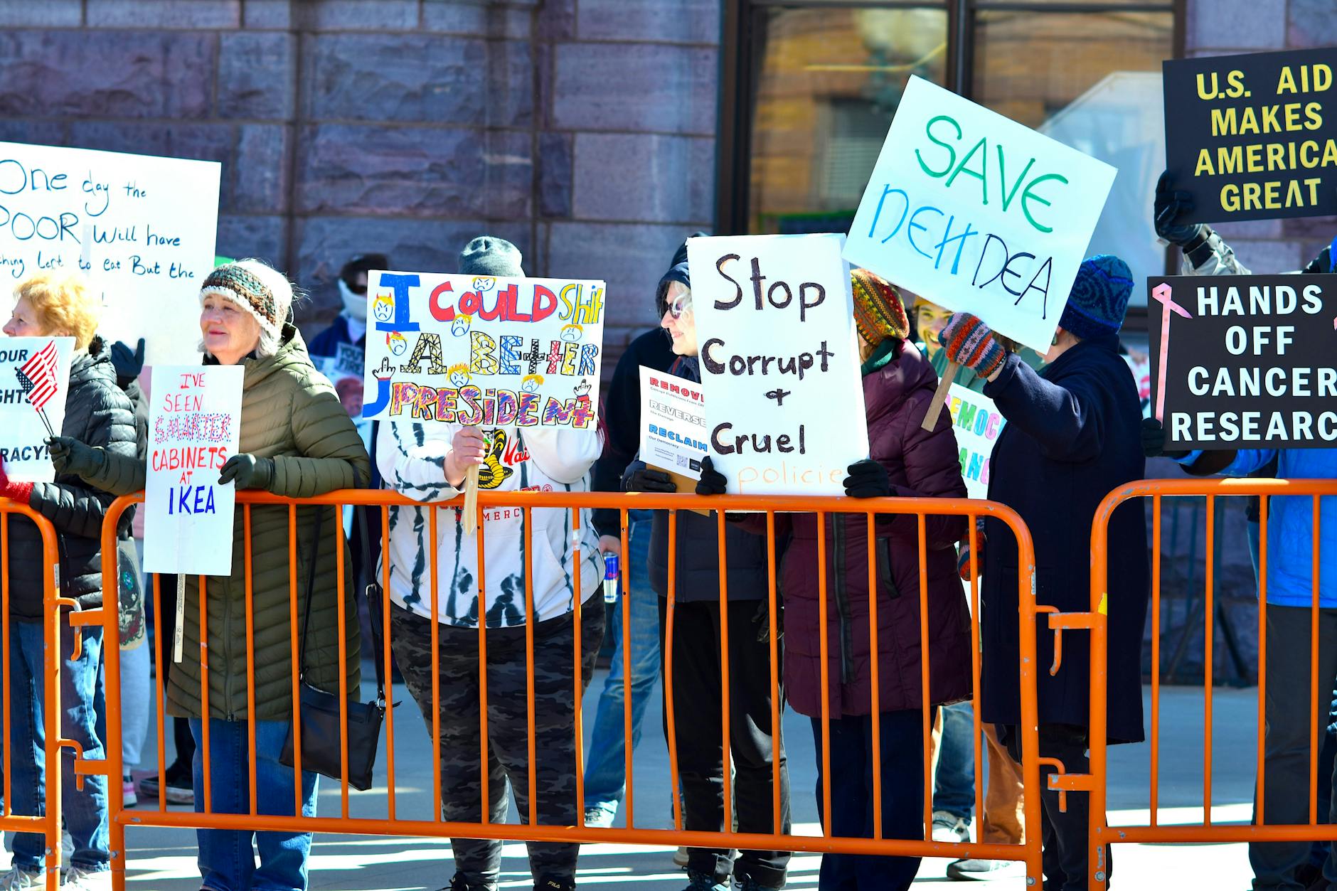 Collection of protest signs and banners held by demonstrators