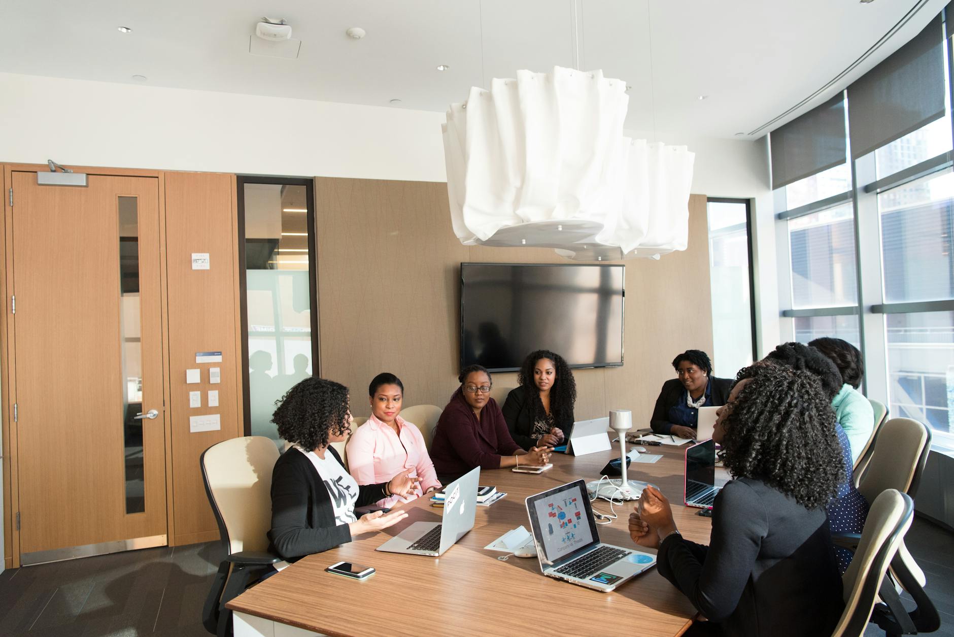 Corporate boardroom meeting with business professionals discussing strategy and documents