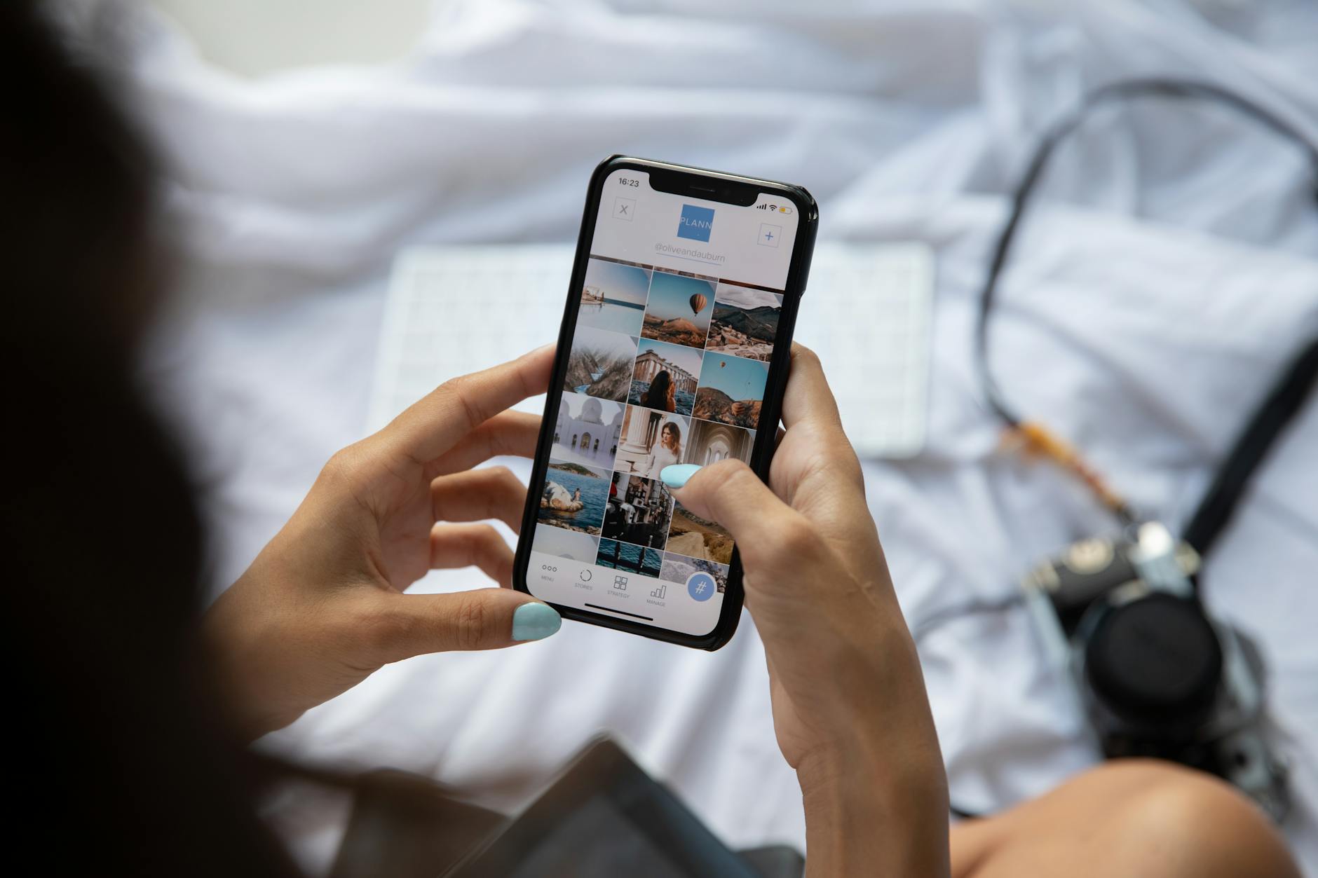 Hands holding smartphone displaying social media interface