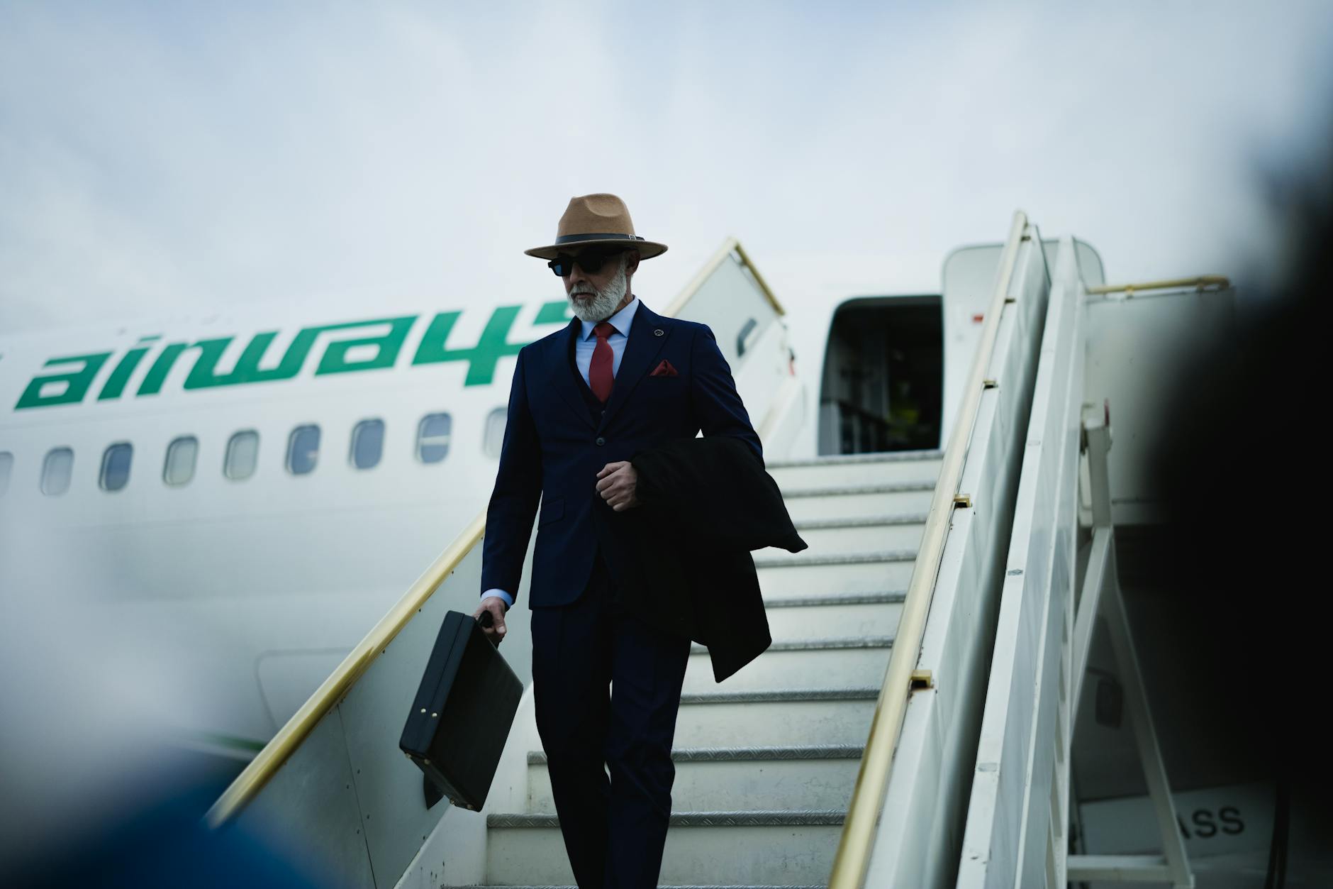 Business travelers with luggage walking through modern airport terminal