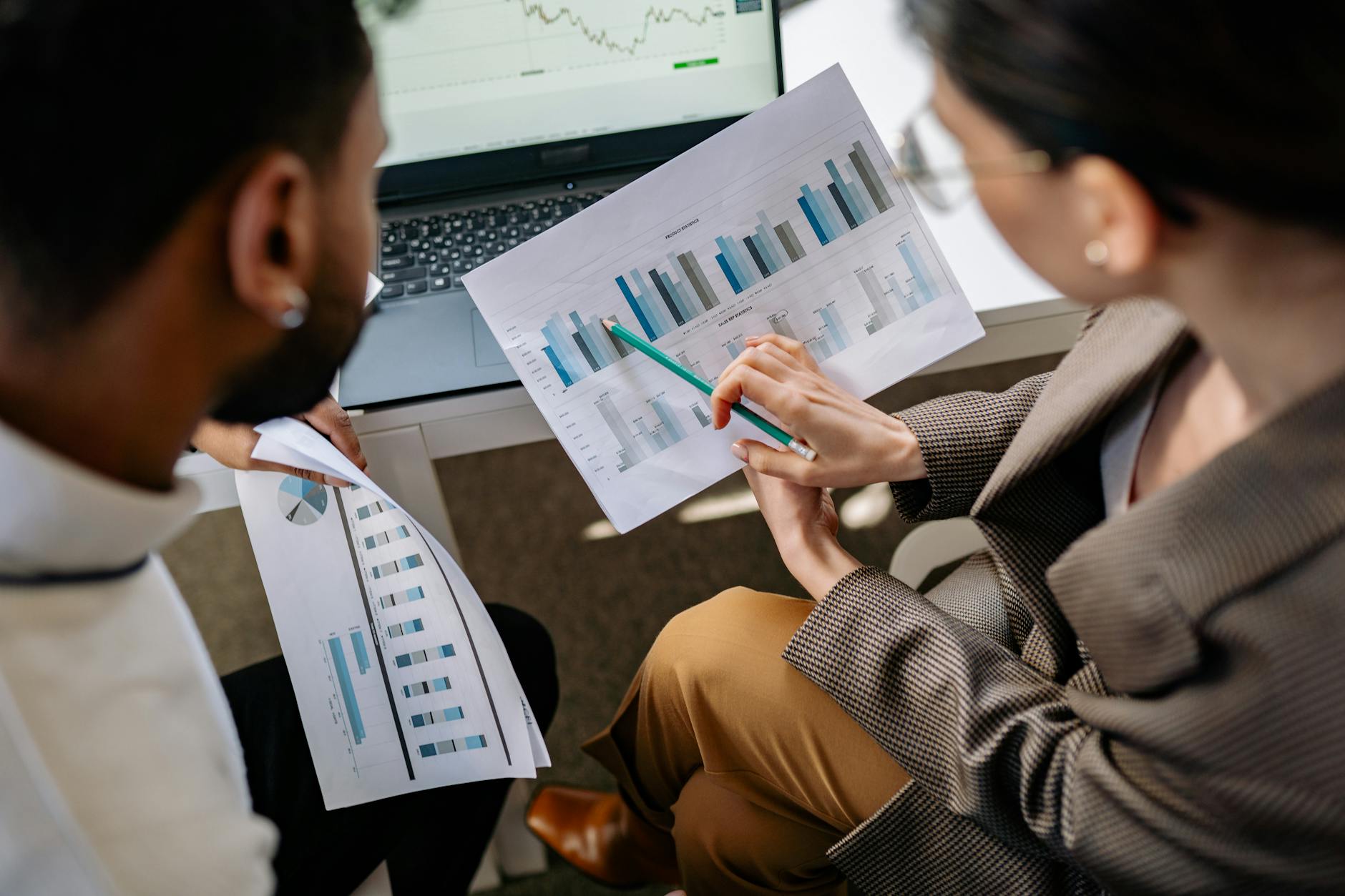 Marketing professionals analyzing social media analytics and engagement data on computer screens