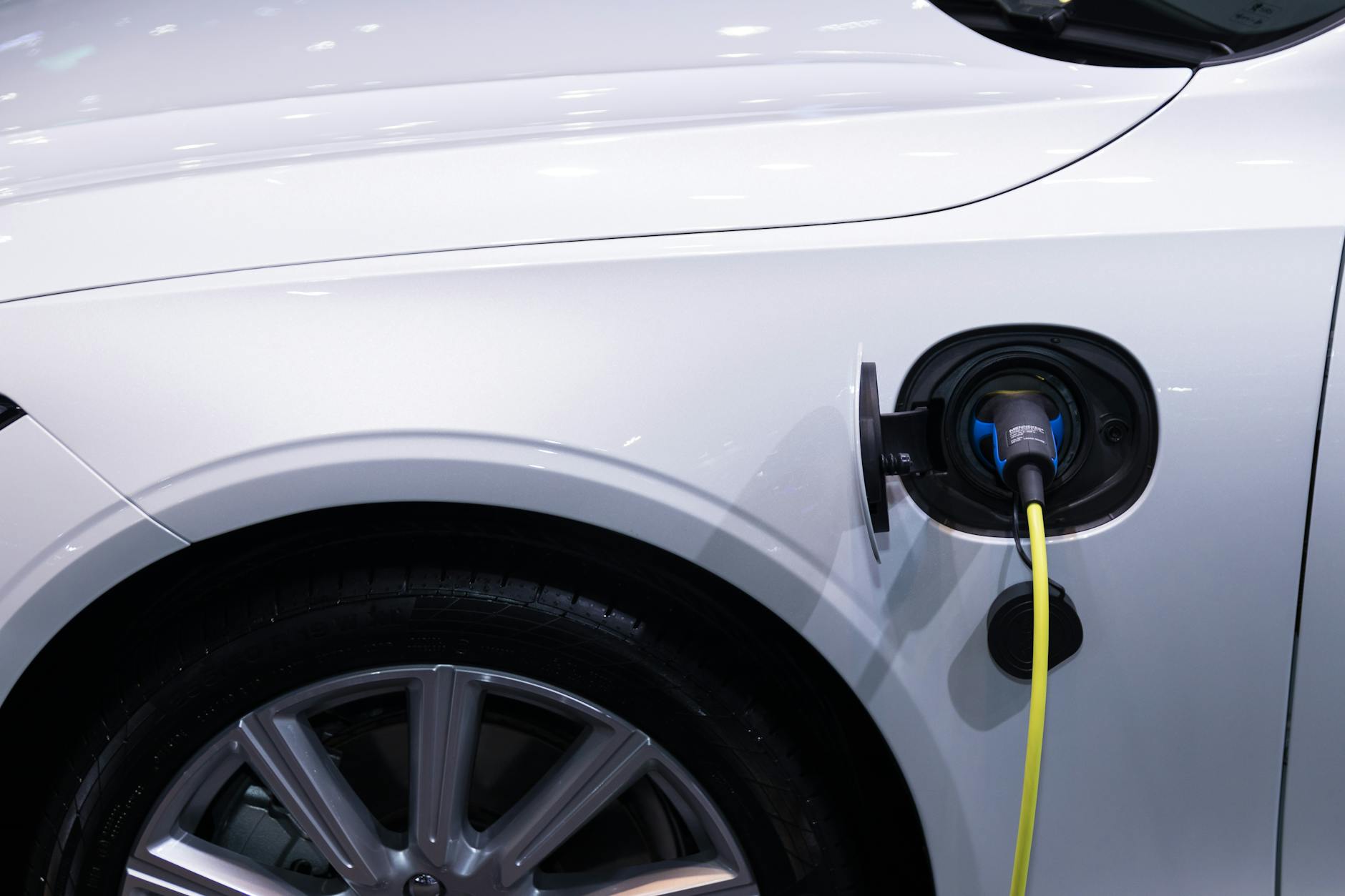 Electric vehicle plugged into charging station