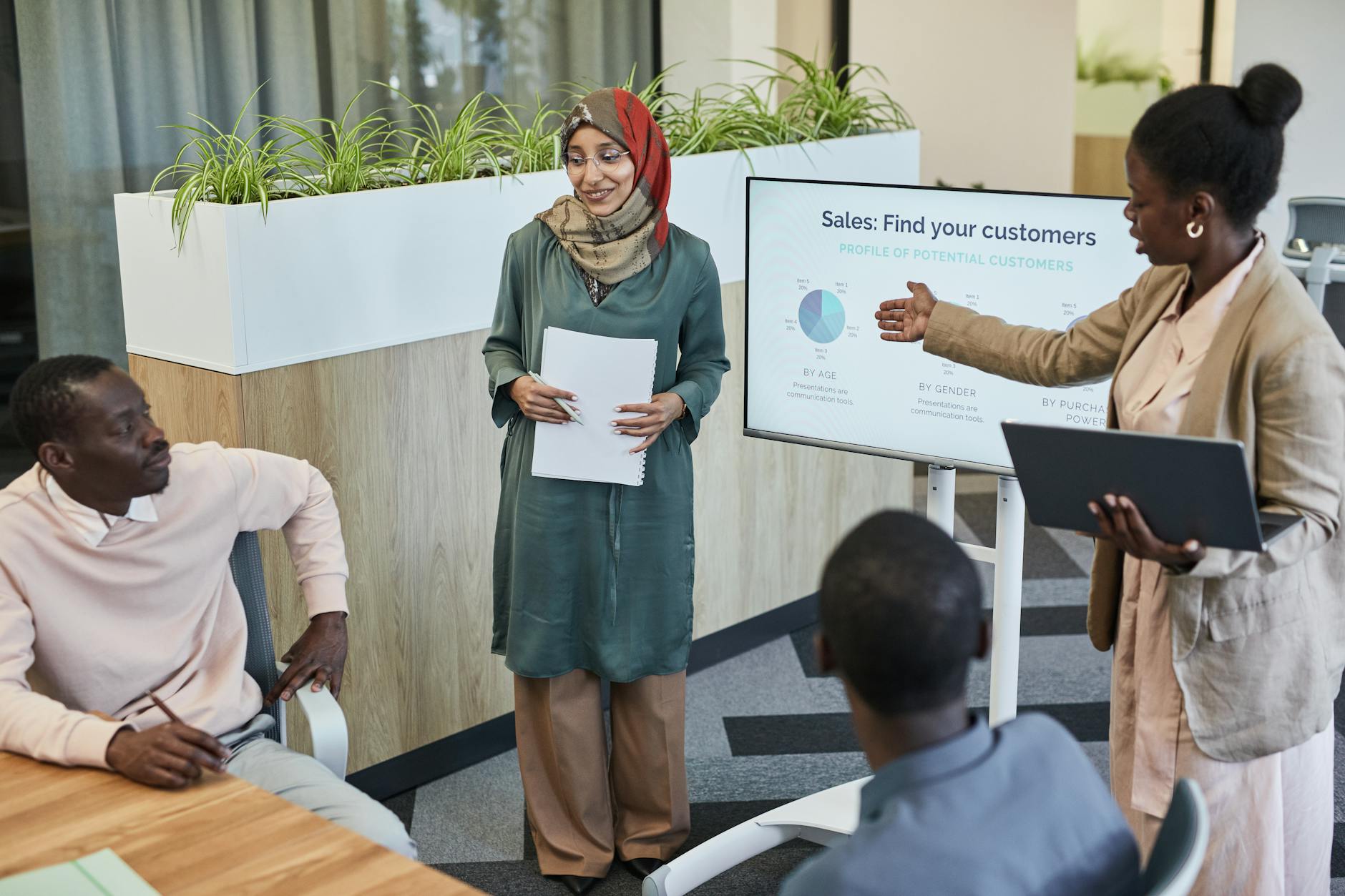 Business professionals in meeting room reviewing marketing campaign analytics and budget reports