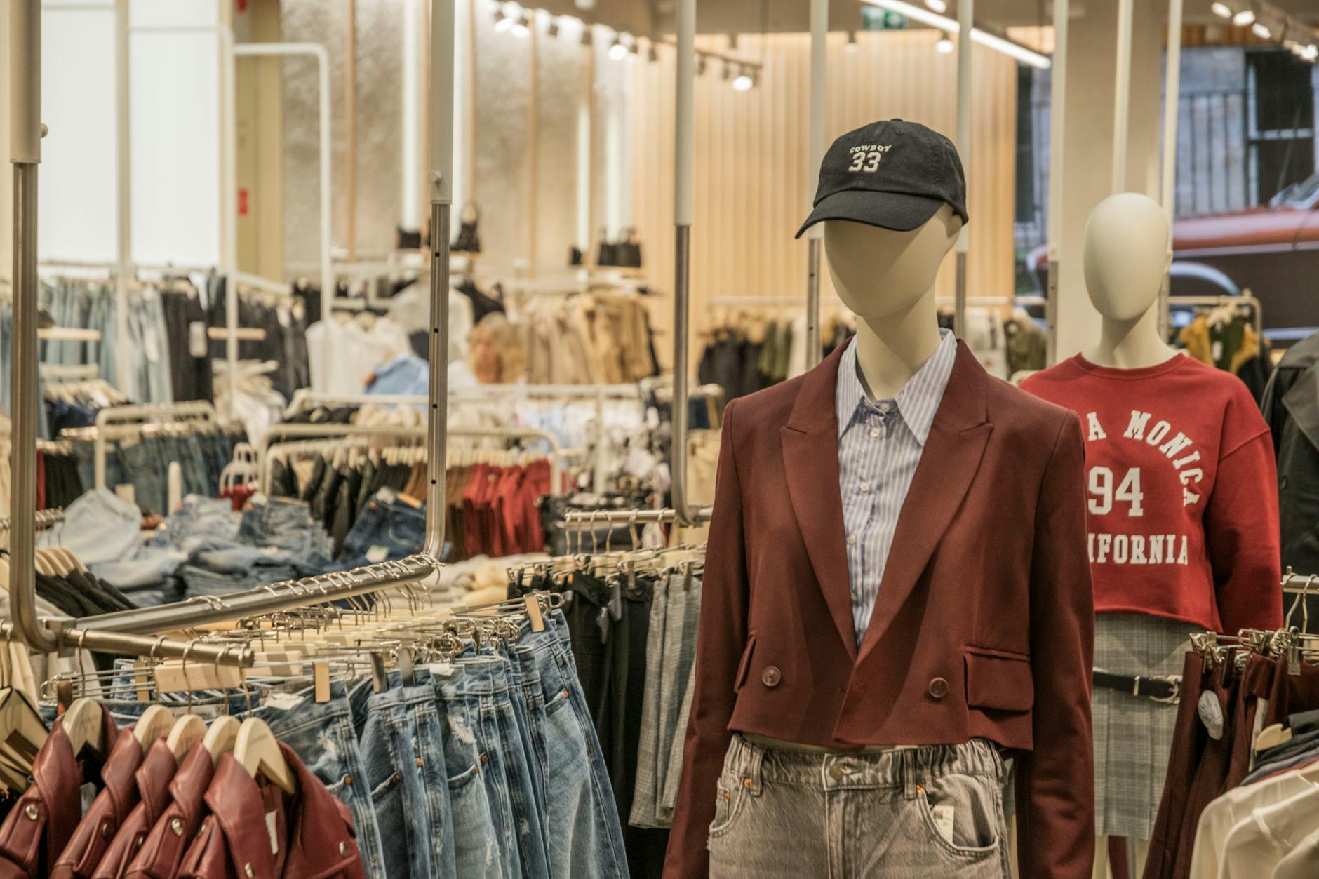 Modern fashion retail store interior with clothing displays and shopping area