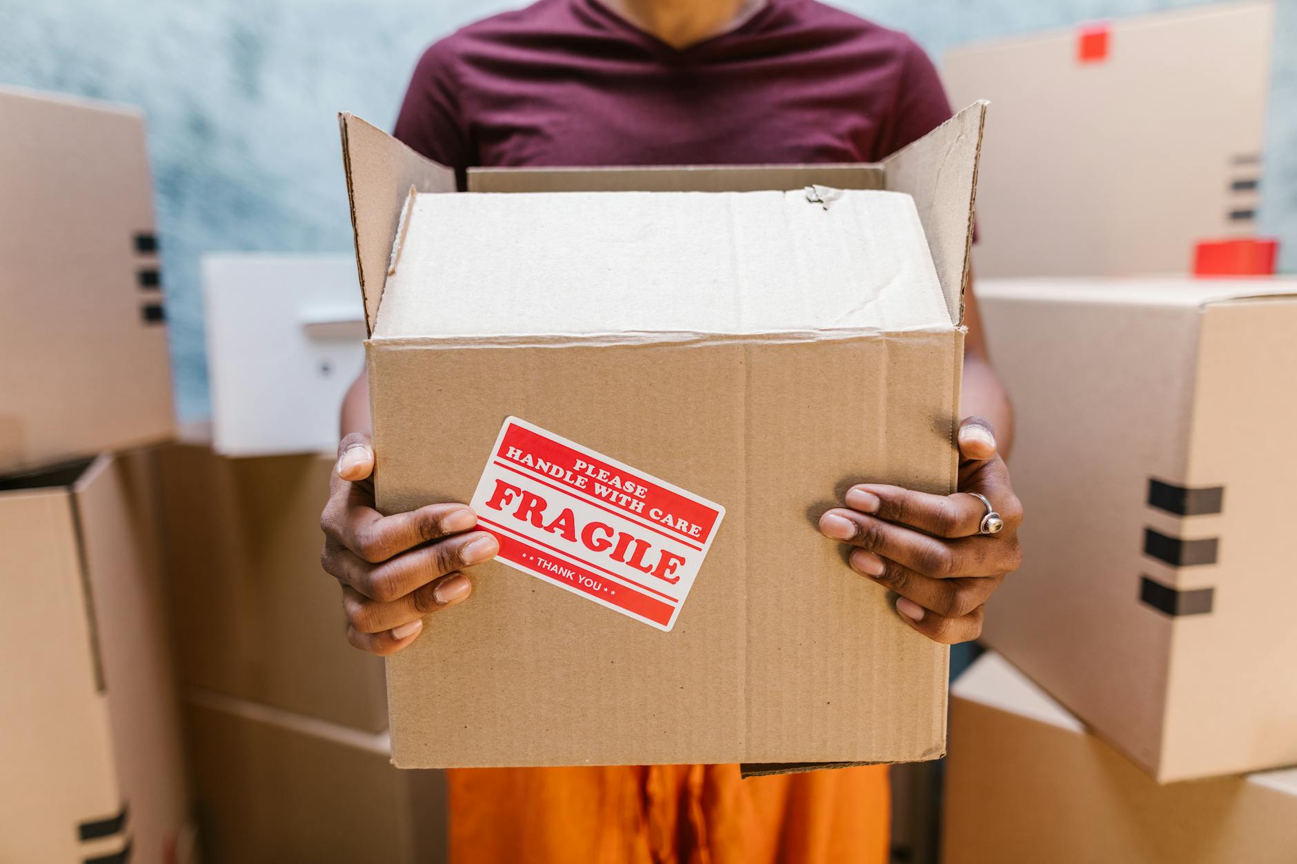 Cardboard moving boxes stacked in empty room during relocation