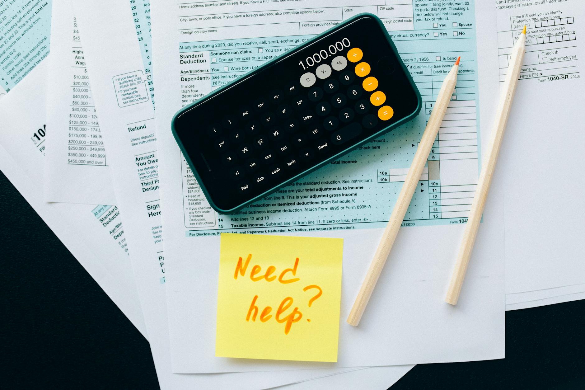 Financial planning documents with calculator and charts showing budget analysis