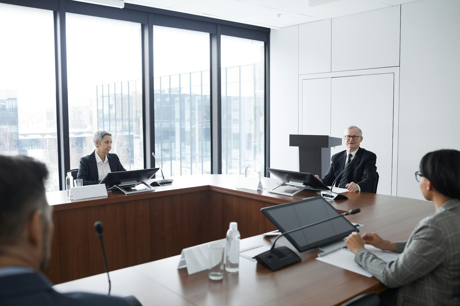 Professional business meeting with documents and laptops on conference table