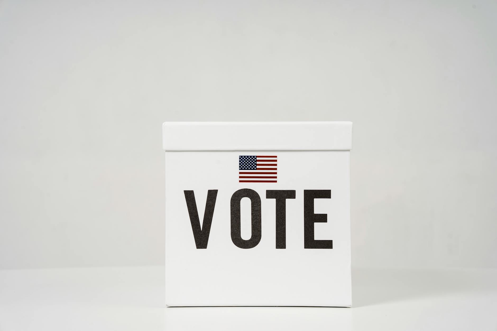 Ballot box with voting slips being inserted during democratic election
