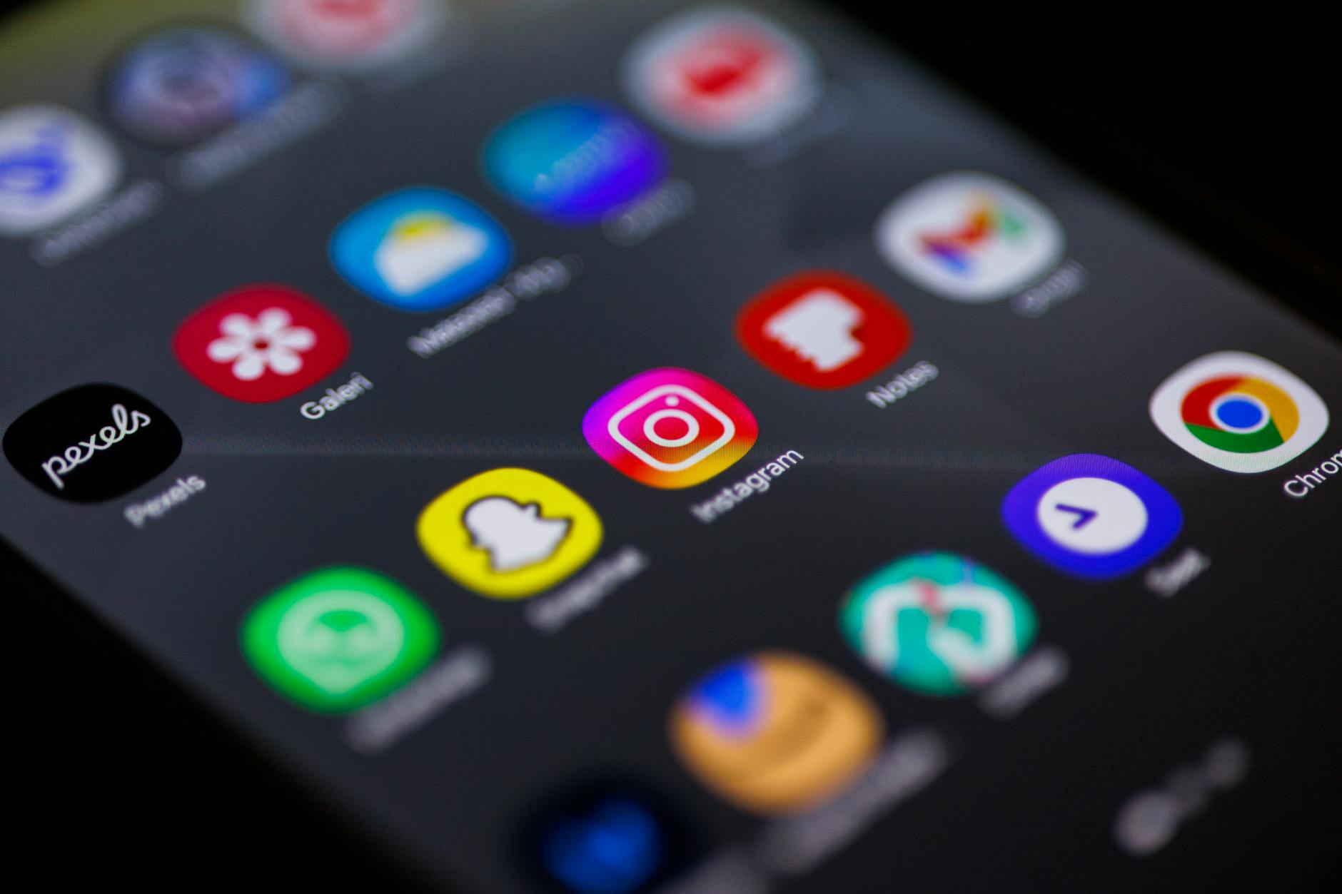 Close-up of smartphone screen showing various streaming service app icons and logos