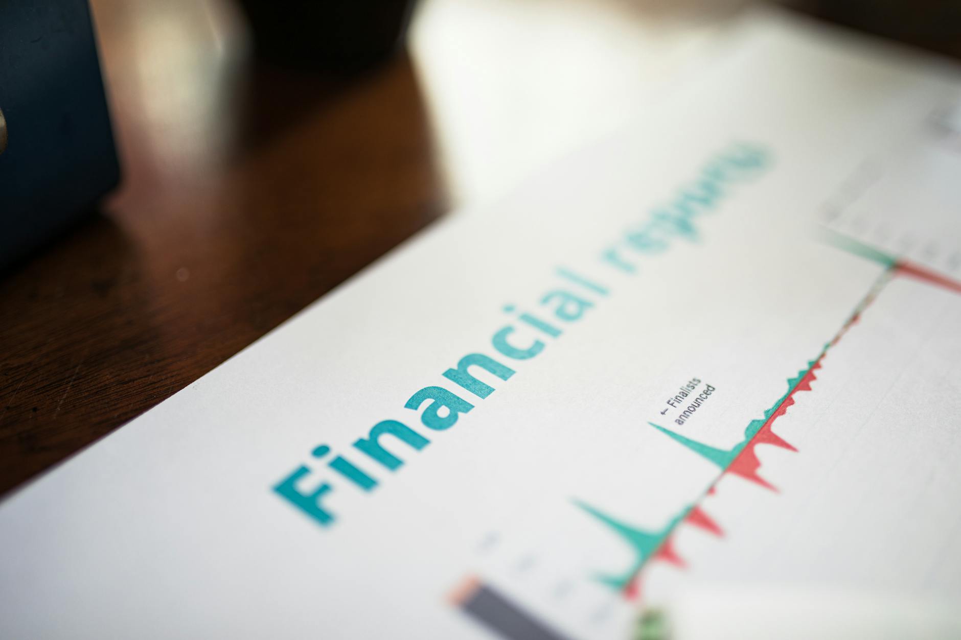 Financial planning documents and calculator on desk showing education costs