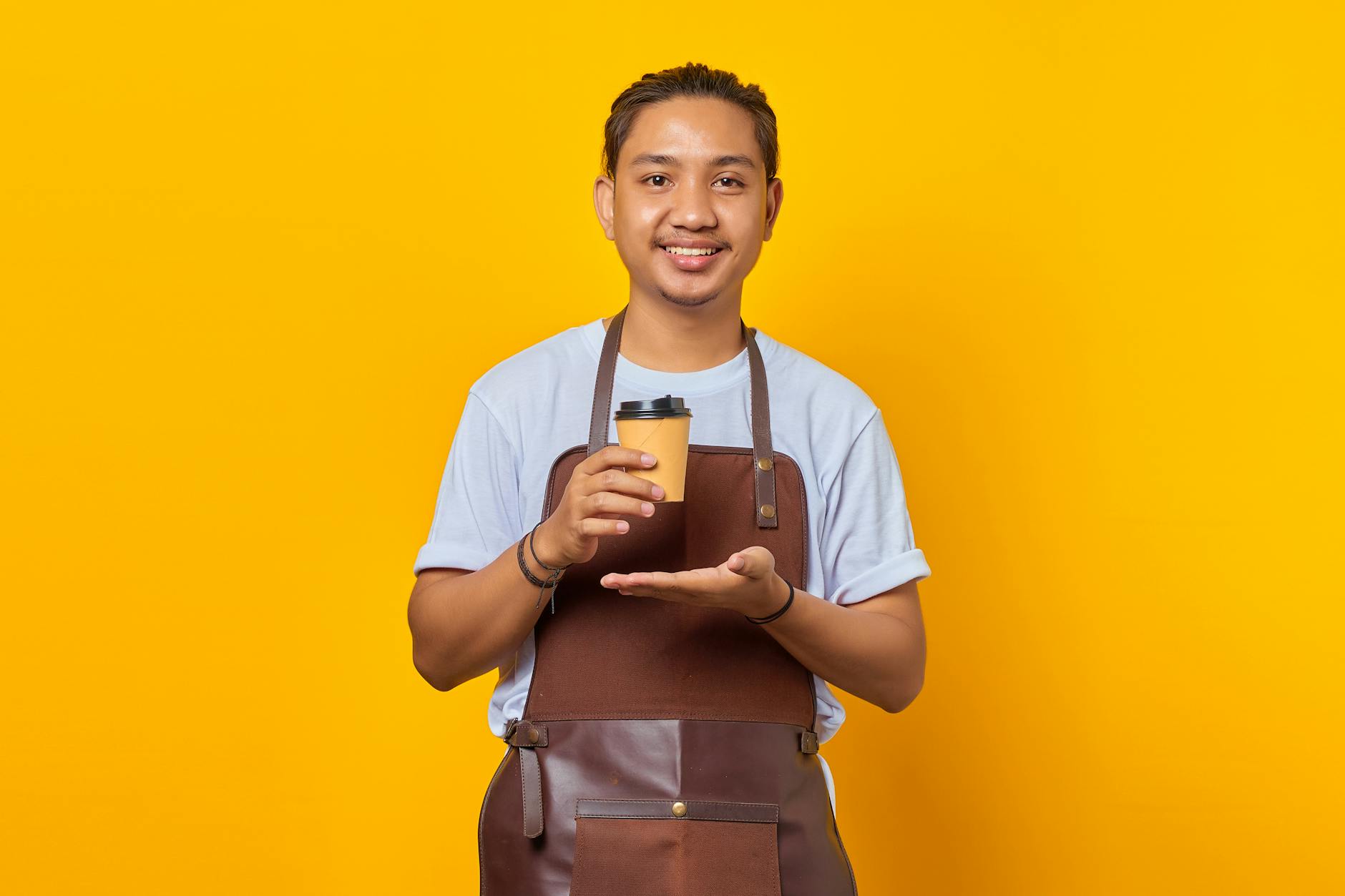 Small business coffee shop owner using technology while maintaining personal customer service