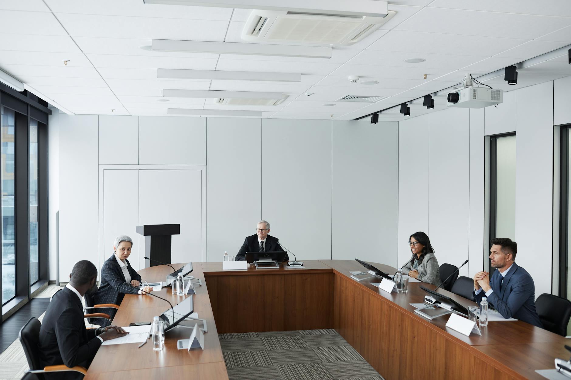 Professional business meeting with executives reviewing financial documents and reports