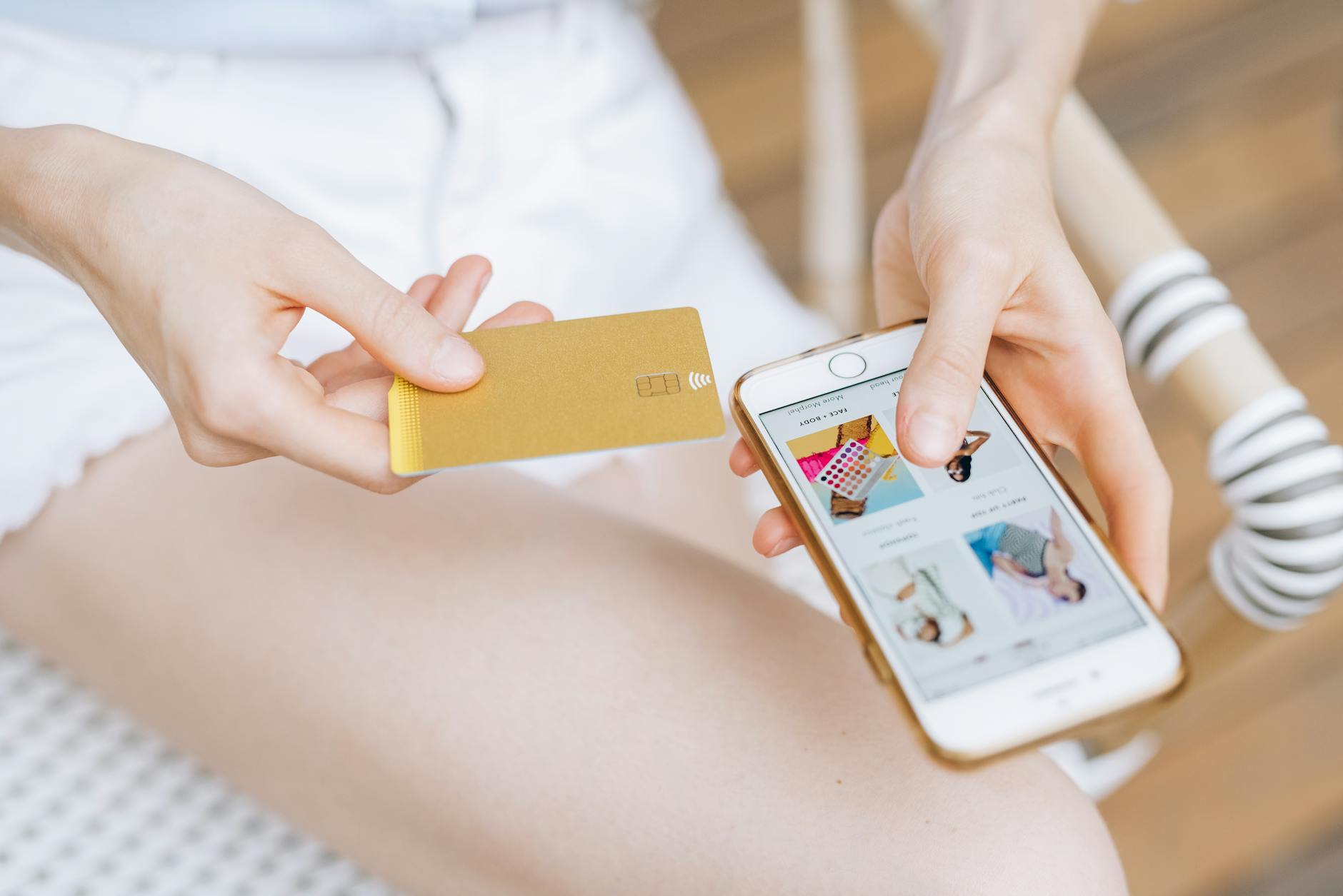 Hand holding smartphone with loyalty program app and membership cards