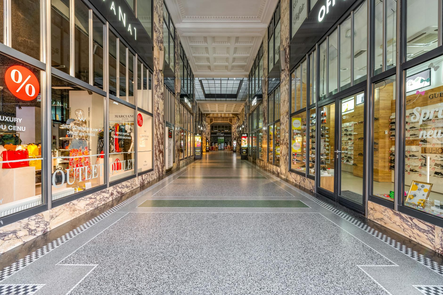 Empty mall interior with vacant storefronts and minimal foot traffic