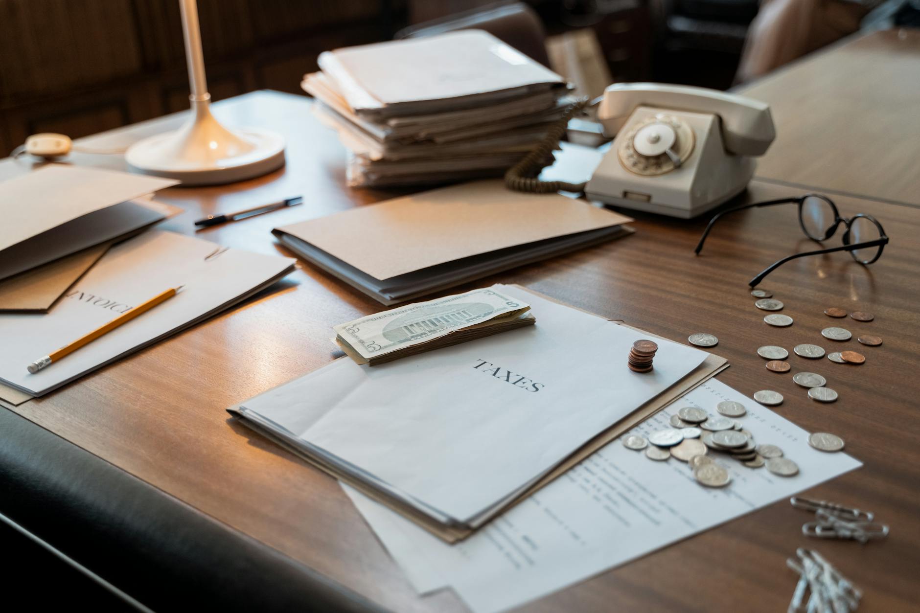 Financial documents and reports spread across a desk representing pension fund portfolio analysis