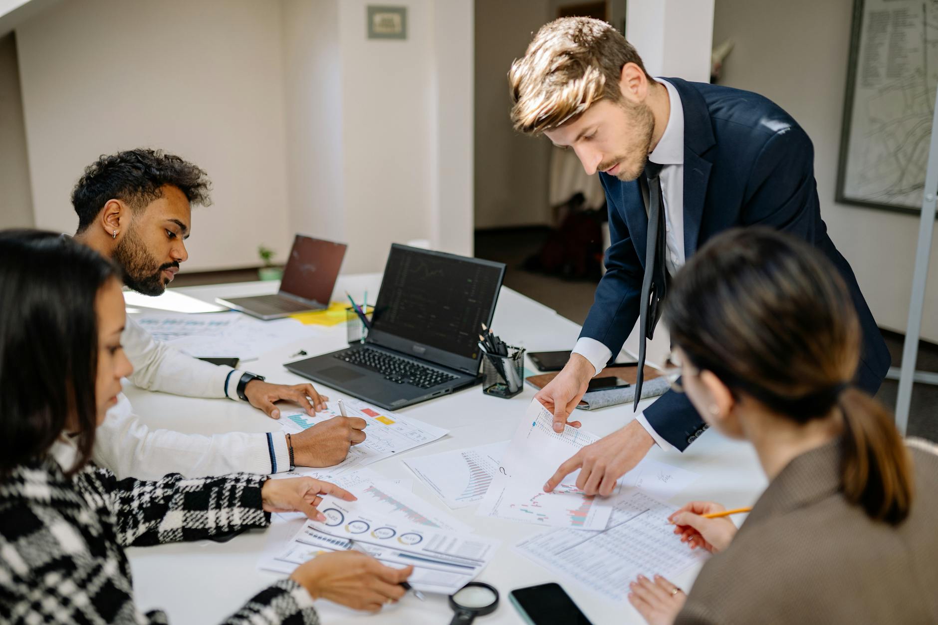 Finance professionals reviewing documents in a meeting room