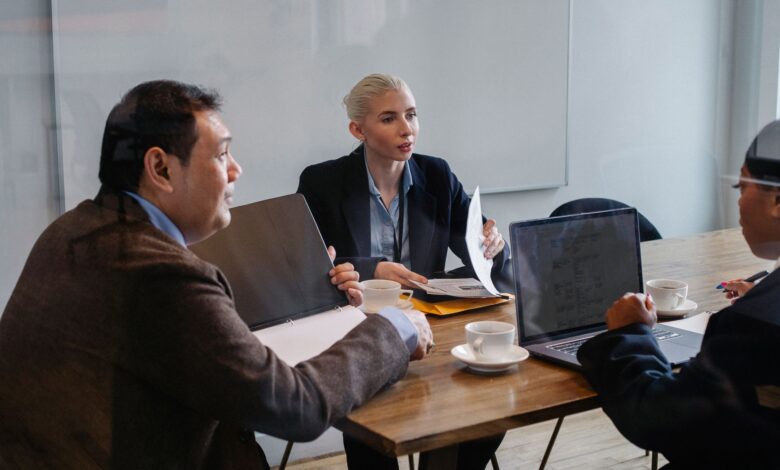 Creative professionals gathered around a conference table in an advertising agency office