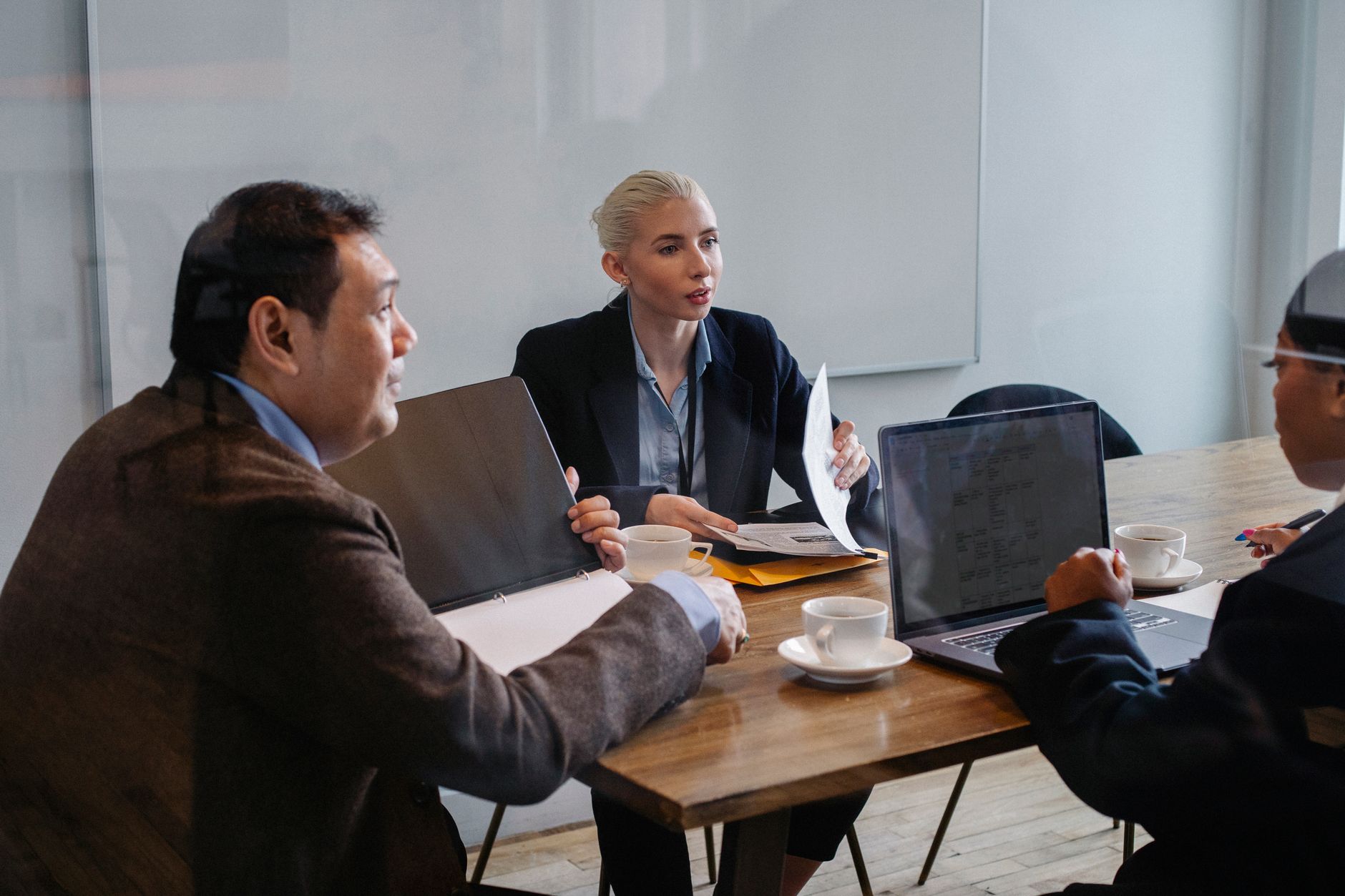 Creative professionals gathered around a conference table in an advertising agency office