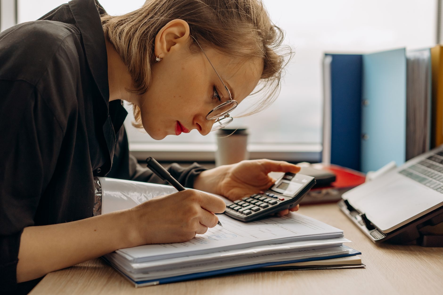 Accountant reviewing financial documents at an office desk