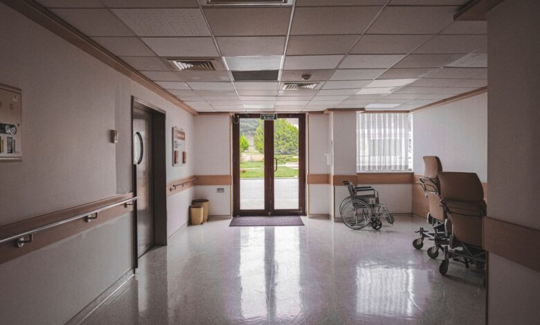 Empty hospital corridor representing institutional healthcare settings