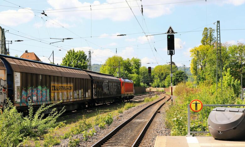 A long freight train carrying intermodal containers across open countryside