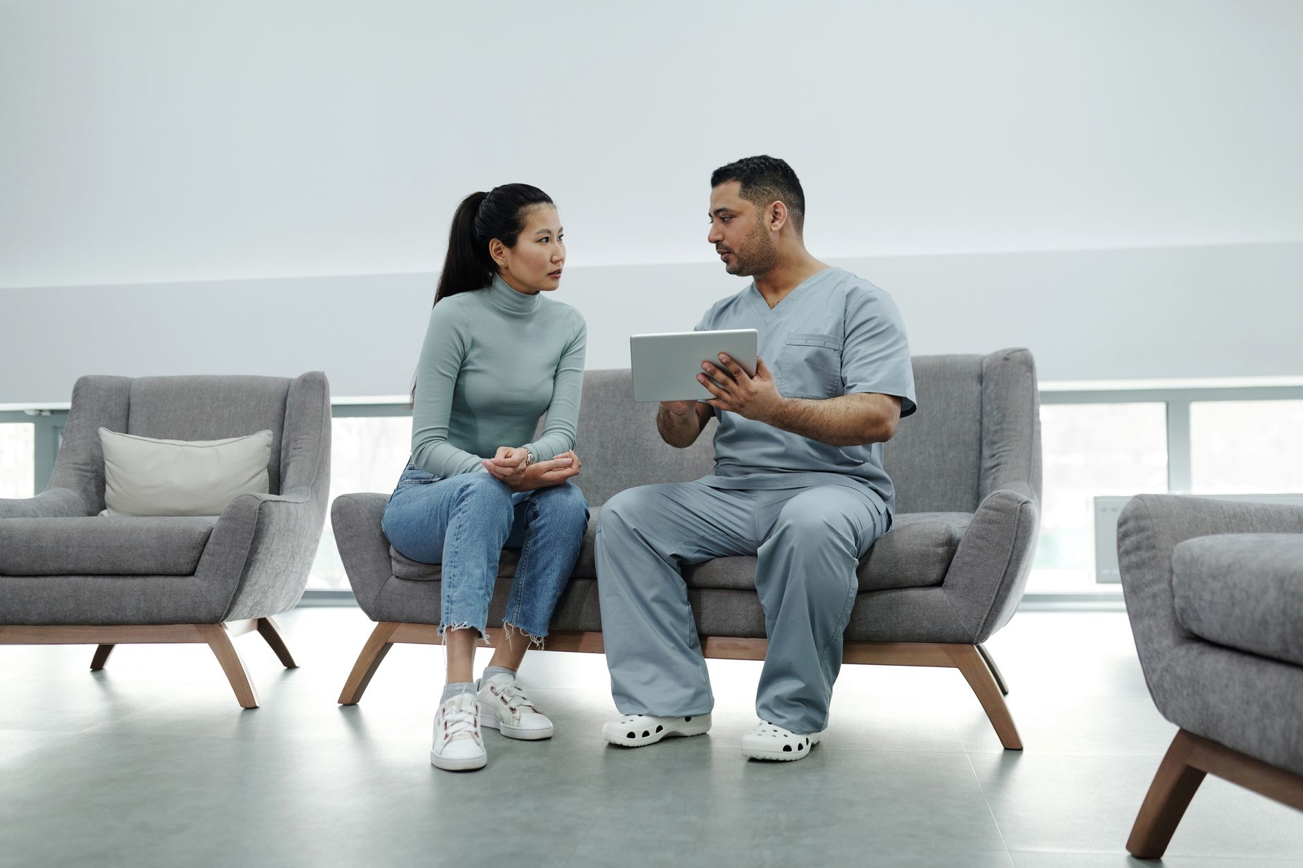 Healthcare professionals reviewing documents in a clinical office setting