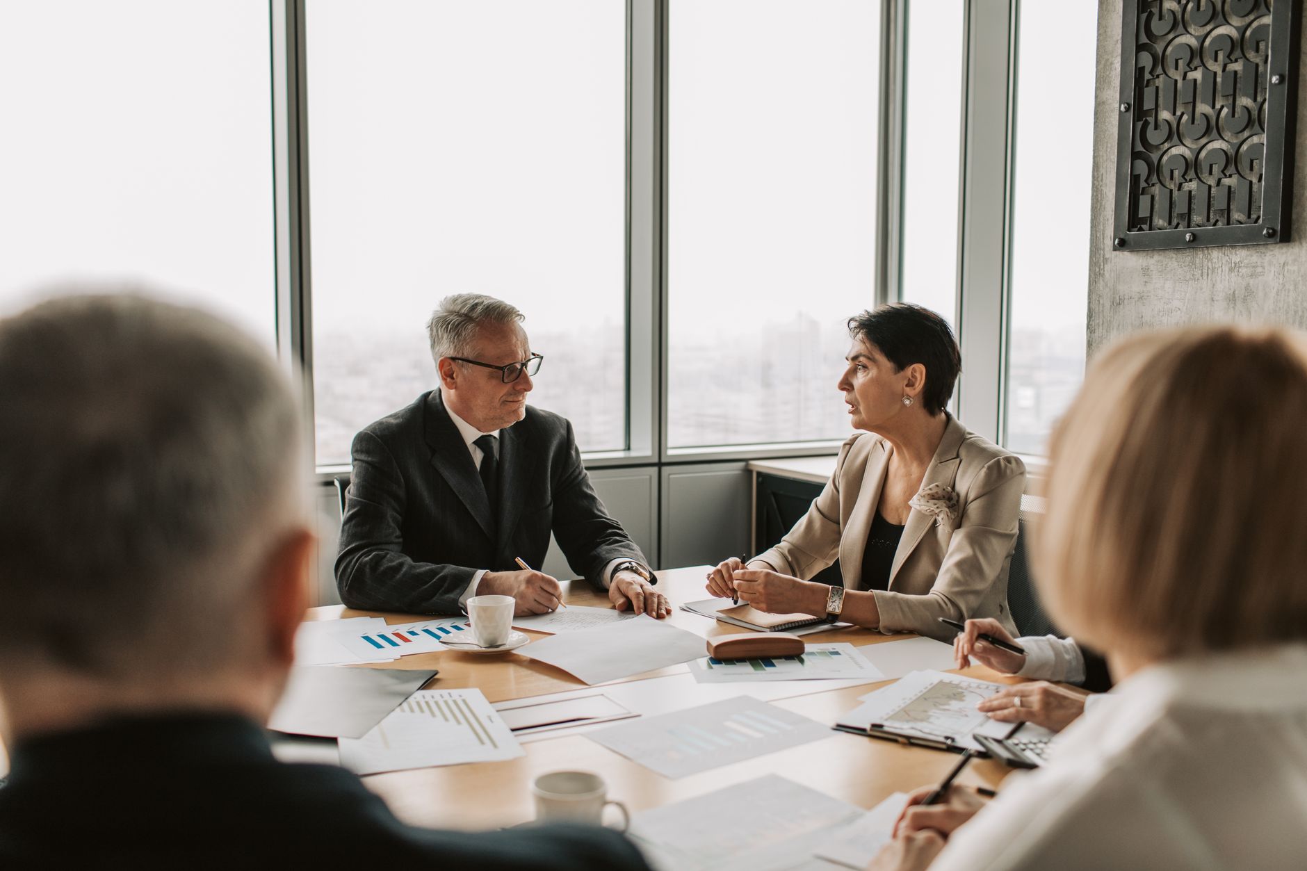 Business professionals reviewing financial data in an office meeting