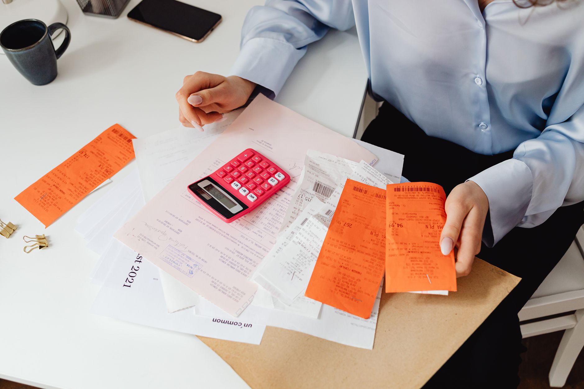 Healthcare administrator reviewing billing paperwork at a desk