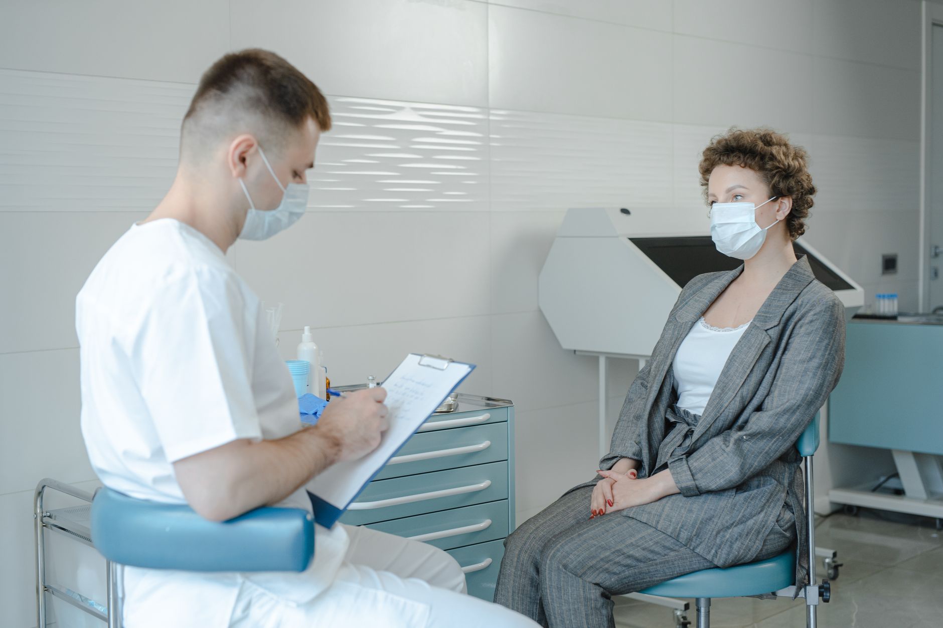 A dermatologist consulting with a patient in an examination room