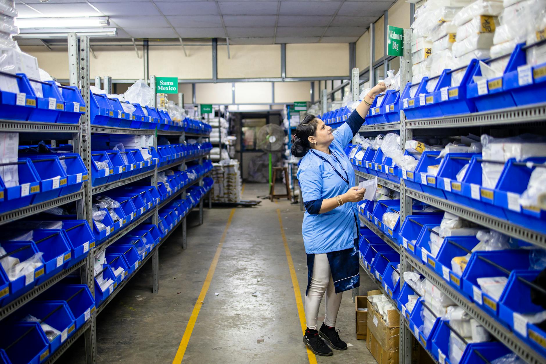 Workers managing freight operations inside a large distribution warehouse