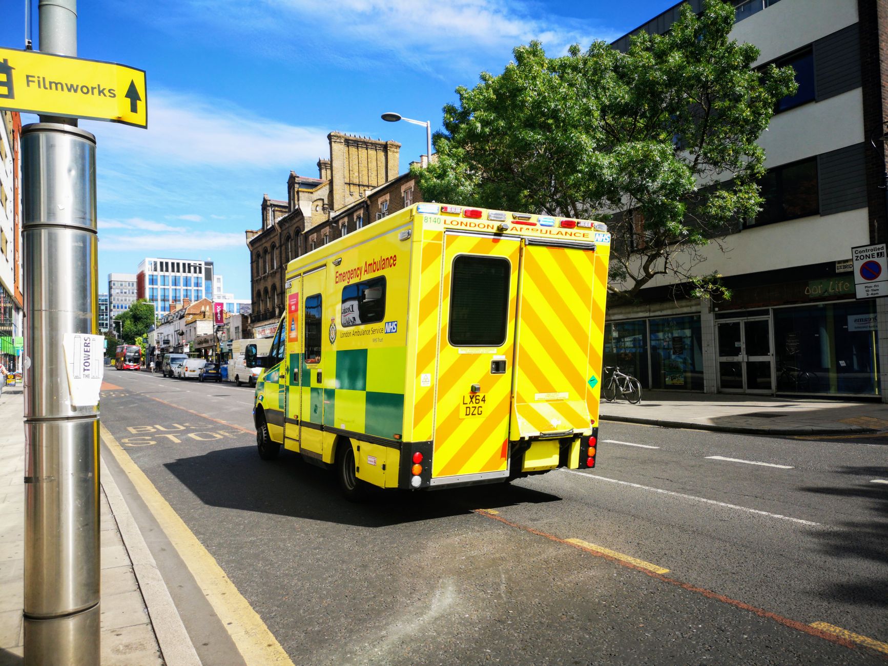 An ambulance driving through a city street representing regional emergency medical services