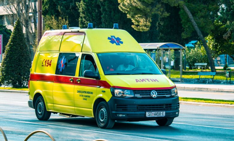 An ambulance parked outside a medical facility representing ground transport services