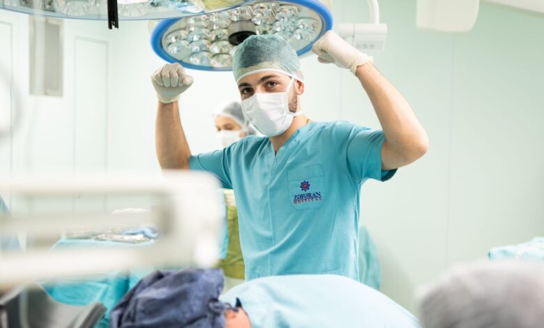 Orthopedic surgeon reviewing patient X-ray in a clinical setting