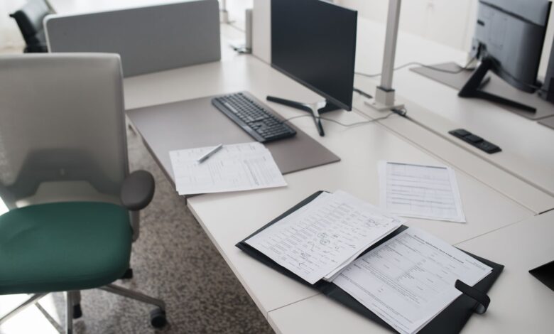 Stack of medical billing paperwork on an office desk