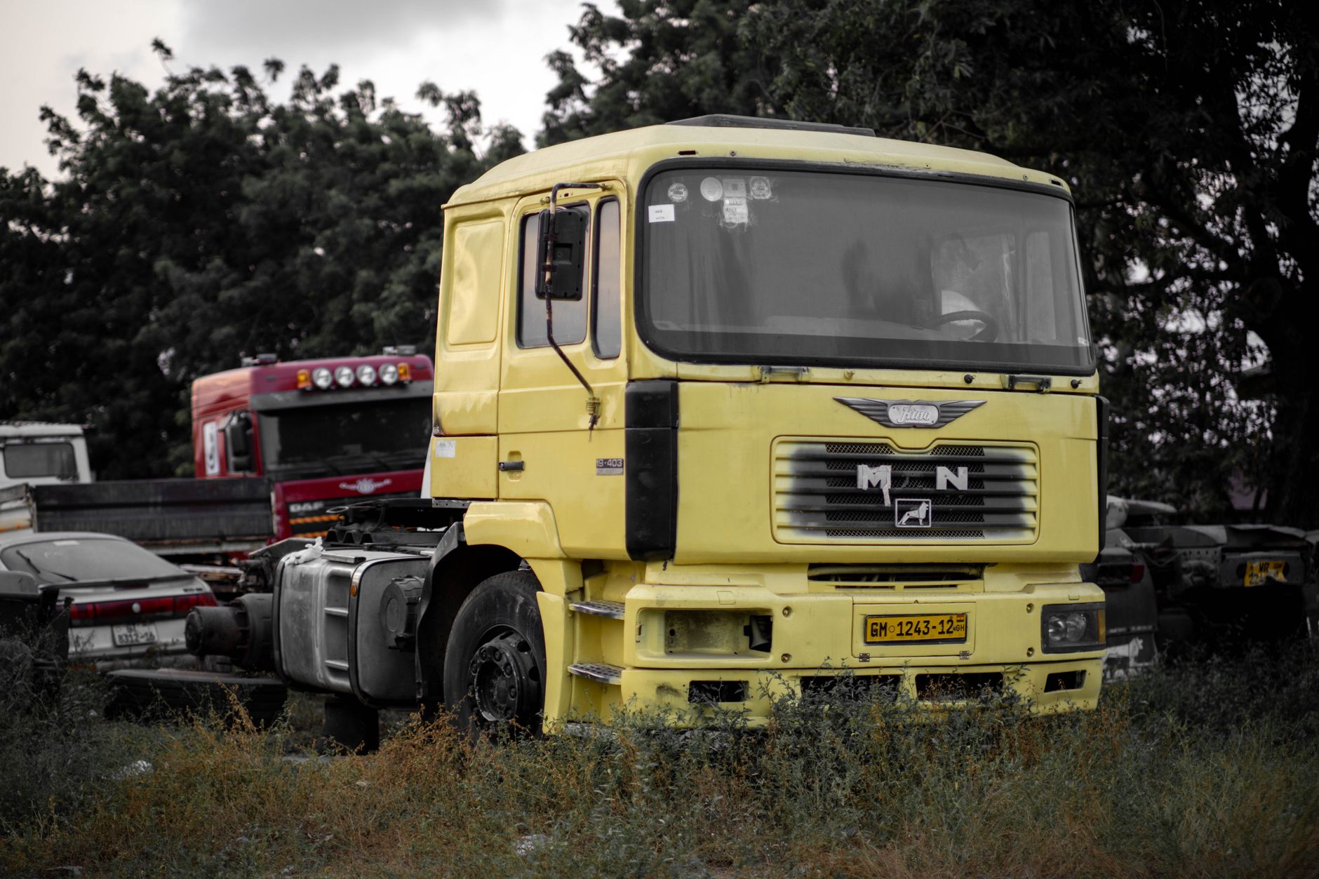 A large fleet of commercial trucks parked in a logistics yard