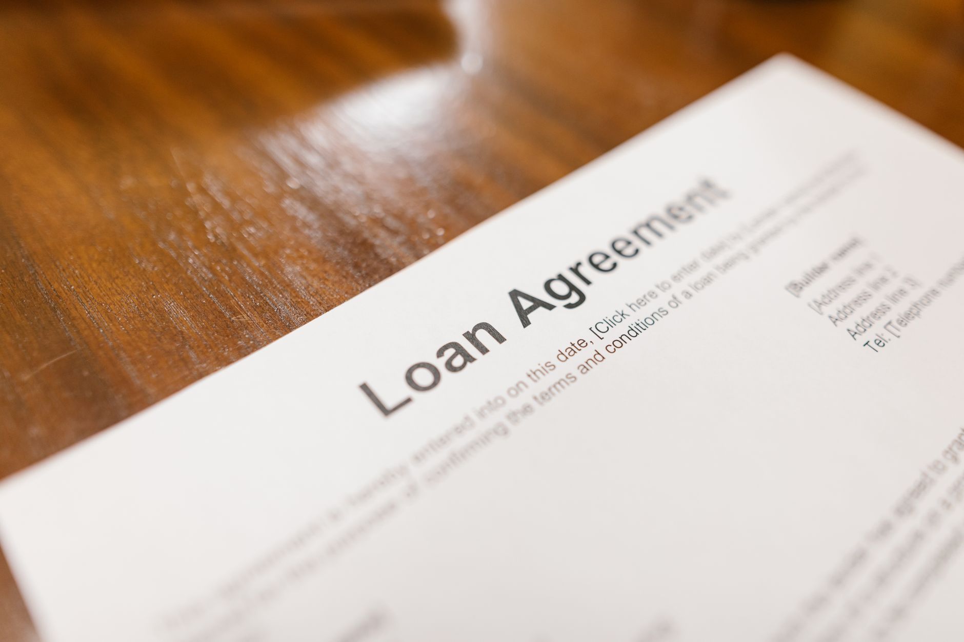 Stack of mortgage loan documents on a desk representing FHA servicing portfolios