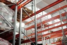 Interior of a large distribution warehouse with shelving and equipment