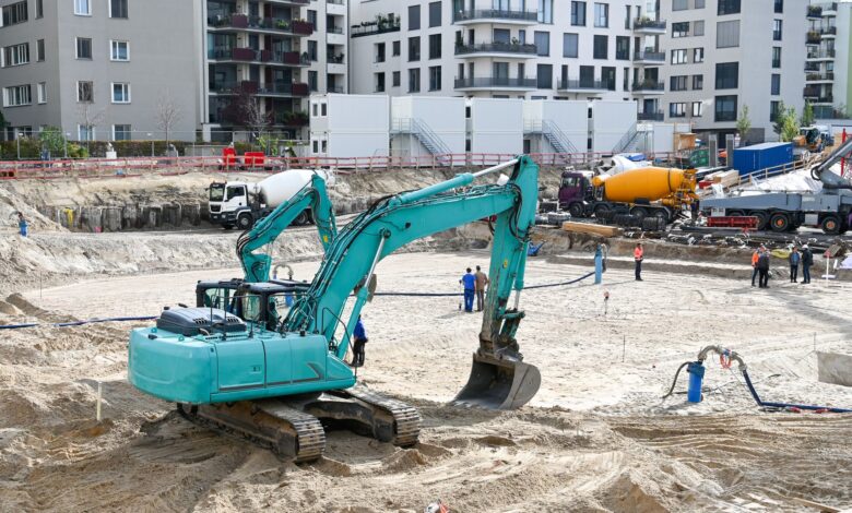 Civil engineers reviewing blueprints at an active construction site