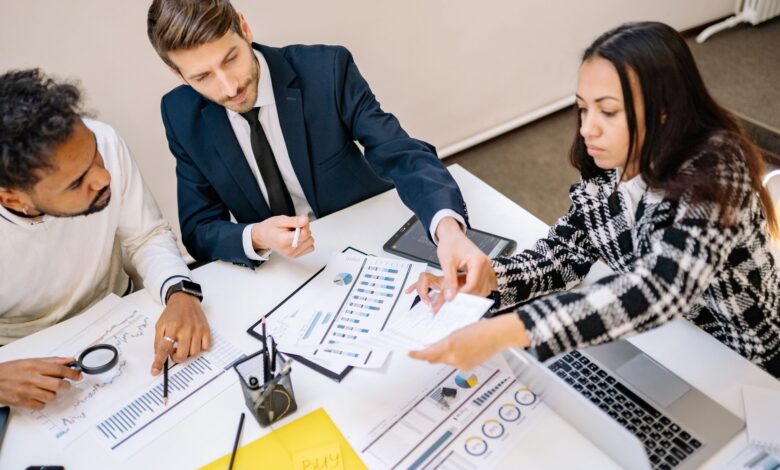Two professionals reviewing commercial insurance documents at an office desk